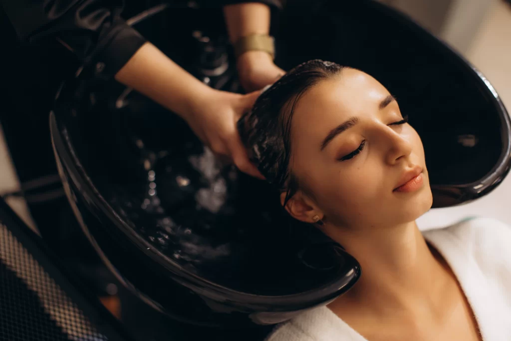 relaxed woman receiving hair wash at salon 2026 03 18 03 24 41 utc