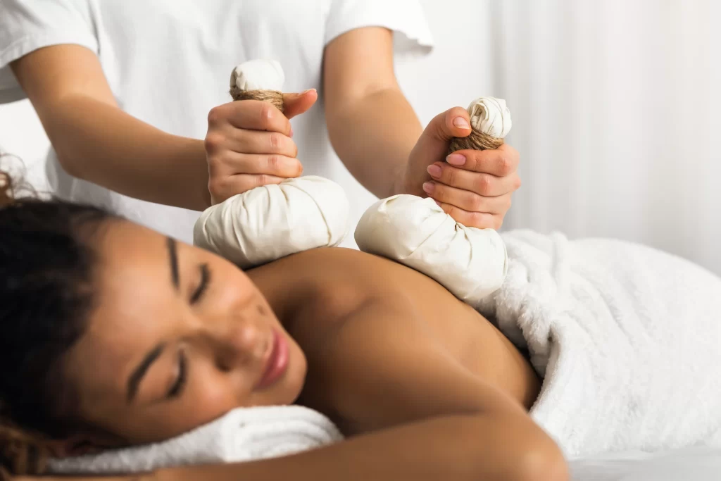 relaxing massage with herbal pouches at the spa 2026 01 08 23 23 17 utc