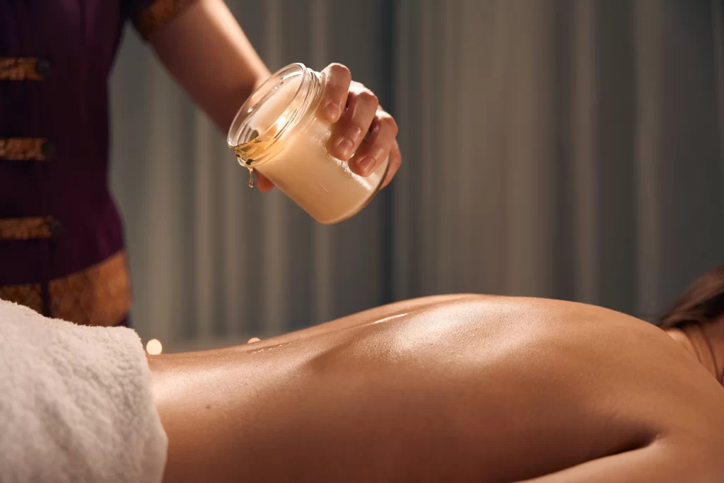 spa therapist preparing patient for scented candle 2026 03 10 02 10 34 utc